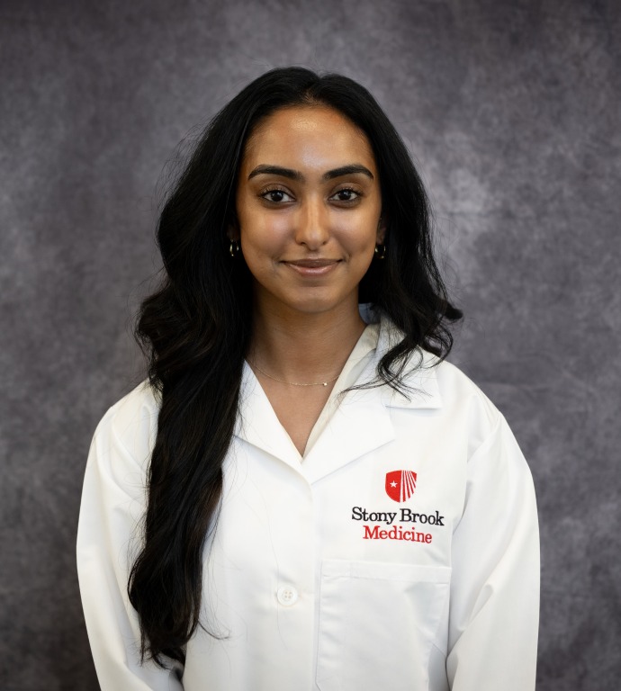 Alisha Thomas Resident in a Doctor's white coat with a gray background