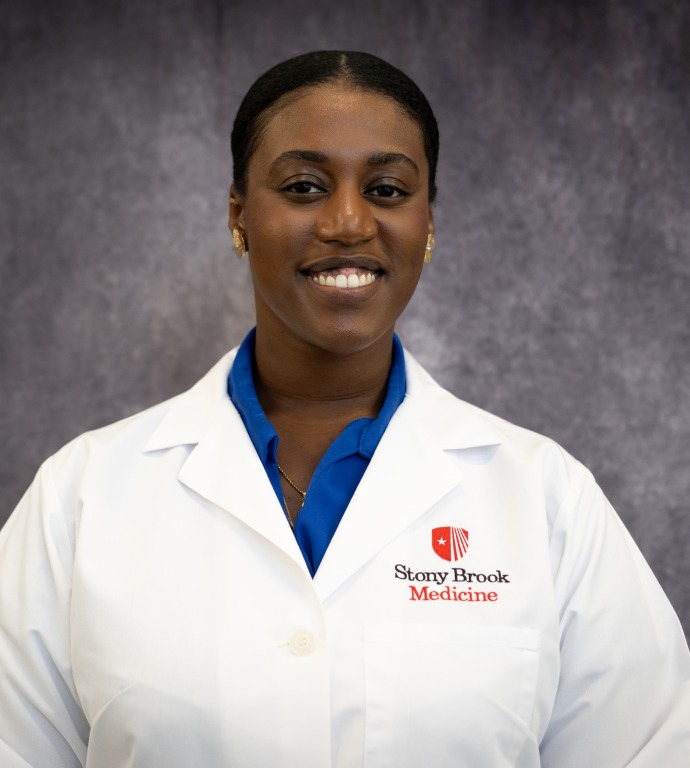 Sadé Taylor Resident in a Doctor's white coat with a gray background