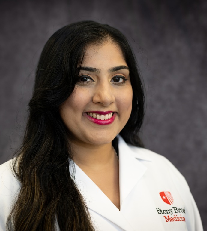Tarandeep Kaur Resident in a Doctor's white coat with a gray background