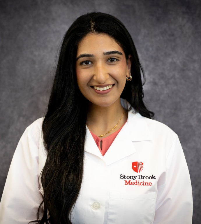 Aditi Mehta Resident in a Doctor's white coat with a gray background