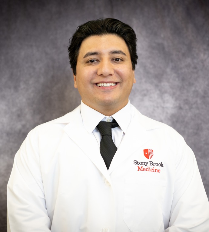 Sohail Khan Resident in a Doctor's white coat with a gray background