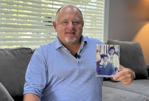 John Weiss with family photo of him and his mom